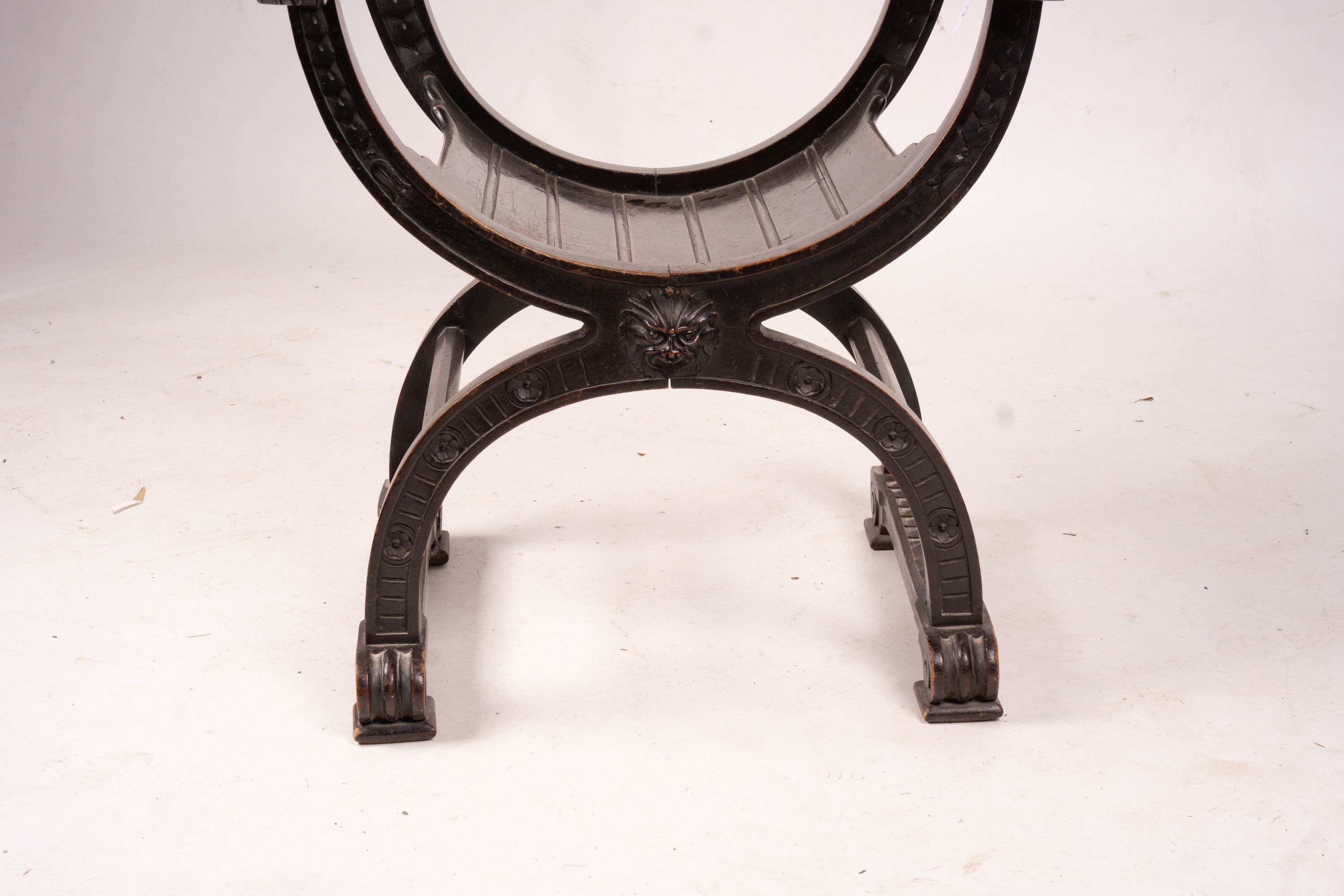 An ebonised Sagrada style elbow chair